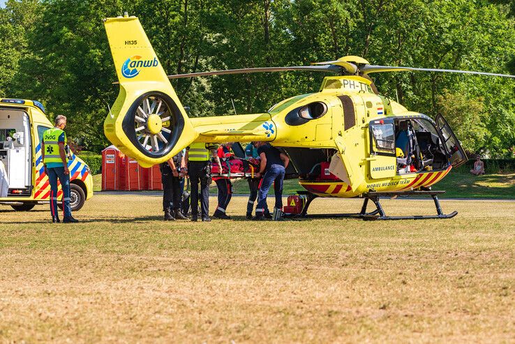 De patiënt wordt achterin de helikopter geladen. - Foto: Peter Denekamp