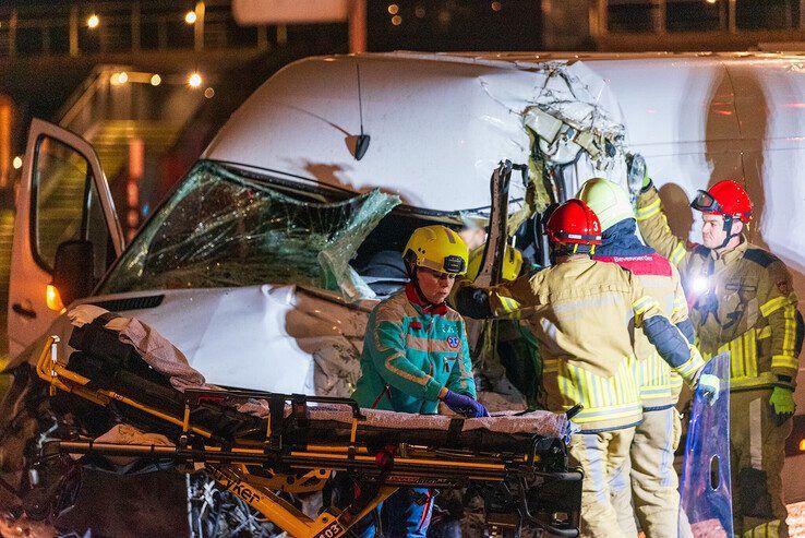 Brandweerlieden knippen de bestuurder uit het wrak op de Ceintuurbaan. - Foto: Peter Denekamp