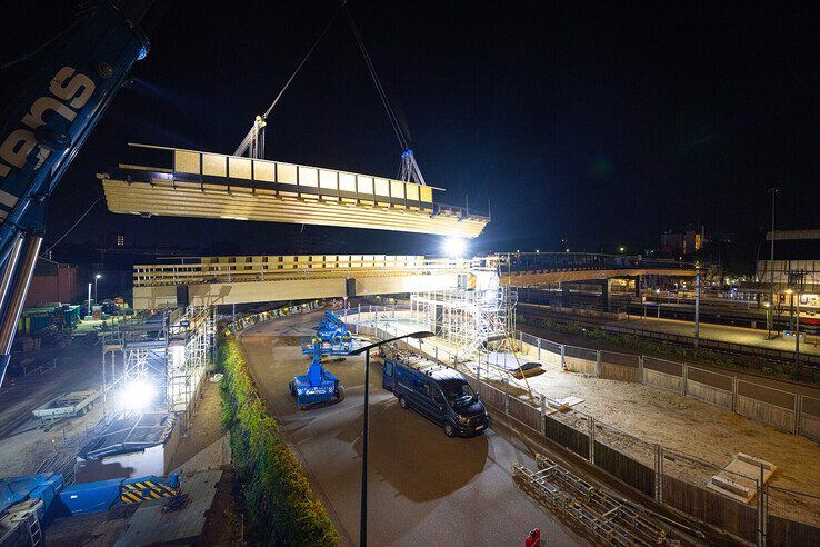 De laatste brugdelen van de houten loopbrug bij het station zijn geplaatst. - Foto: Stefan Verkerk