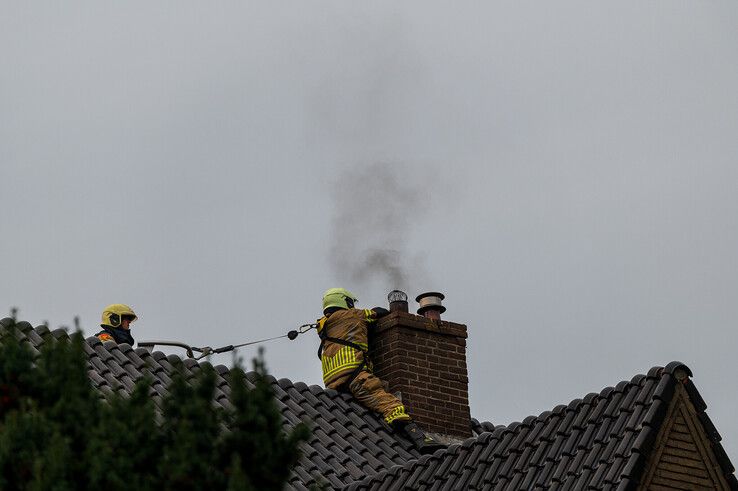 In beeld: Brandweer heeft grote moeite om bij schoorsteenbrand te komen in Zwolle - Foto: Peter Denekamp