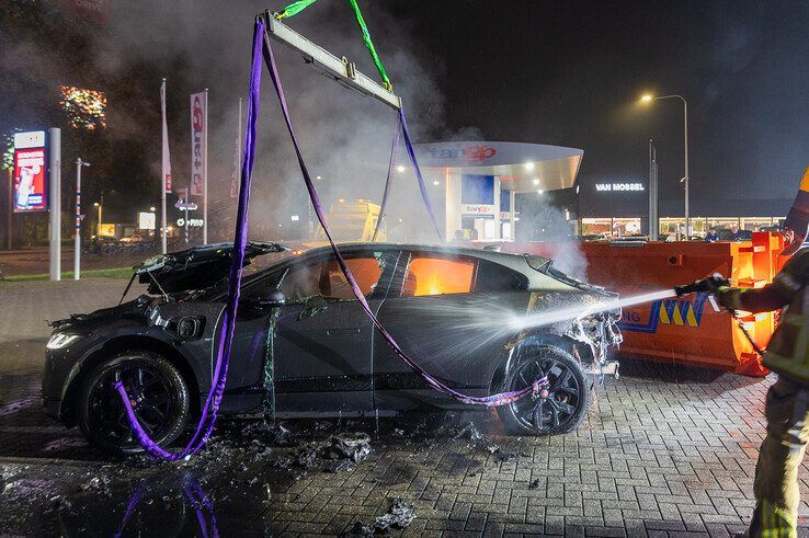 In beeld: Elektrische auto aan laadpaal vliegt in brand in Zwolle, brandweer urenlang in touw - Foto: Peter Denekamp