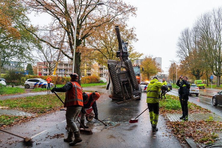 In beeld: Graafmachine valt uit vrachtwagen in Holtenbroek, fietsster lichtgewond - Foto: Peter Denekamp