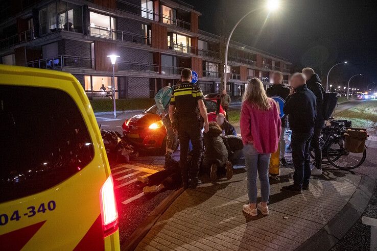 Ambulancepersoneel ontfermt zich over de gewonde scooterrijdster. - Foto: Hugo Janssen