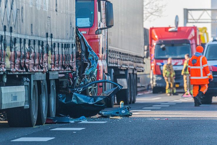 De auto met moeder en dochter zit klem tussen beide trucks op de A28 bij Zwolle.