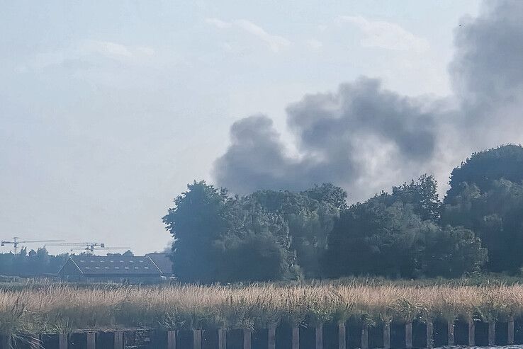 Zwarte rookwolken trekken over Zwartsluis: brand in berg schroot op bedrijfsterrein